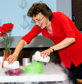 Dr. Tatiana Erukhimova pouring liquid nitrogen on balloons.